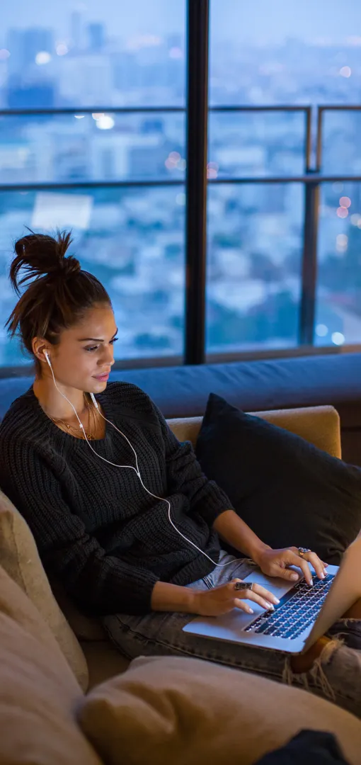 Young woman at home on laptop